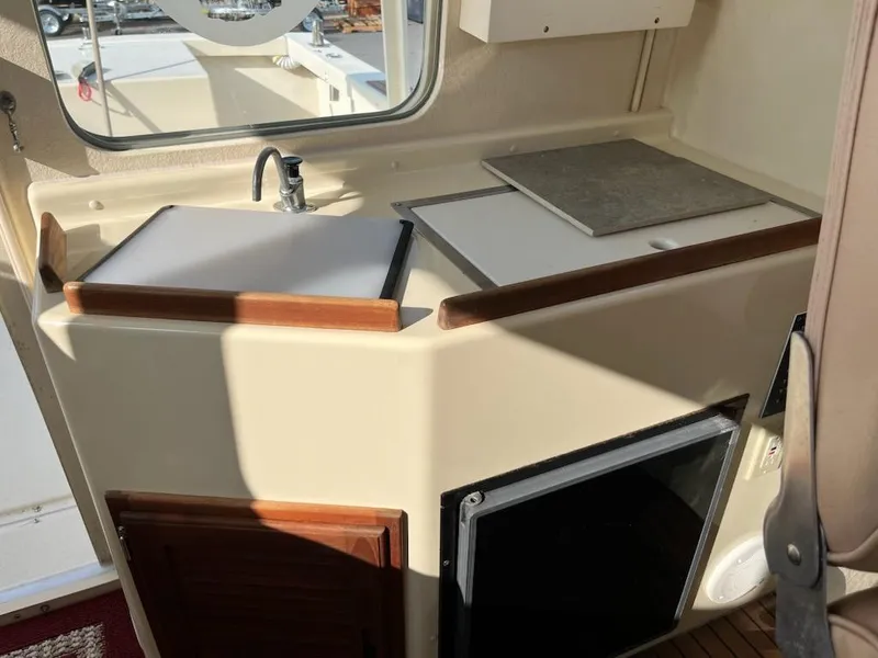Slide: The Image of 2001 Rosborough RF-246 Custom Wheelhouse interior with compact kitchenette and sink. - 4
