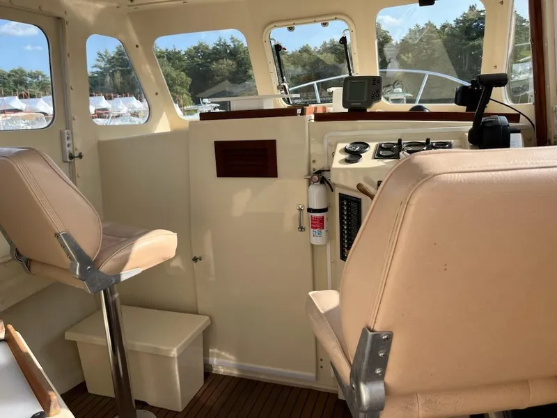 Slide: The Image of Interior of 2001 Rosborough RF-246 Custom Wheelhouse with beige seating and navigation equipment. - 7