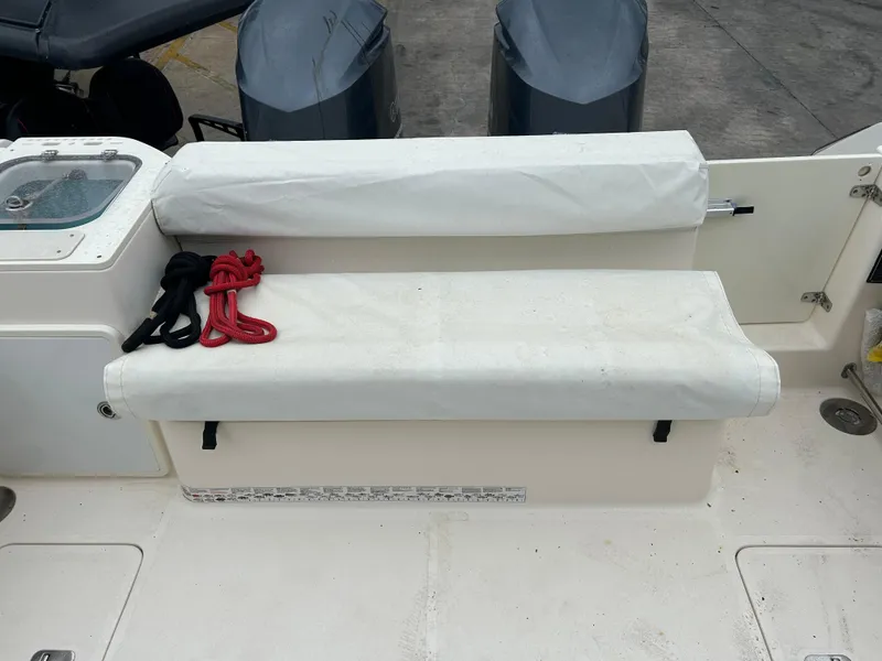 Slide: The Image of 2011 Pursuit OS 315 Offshore boat seating area with ropes and dual engines. - 7