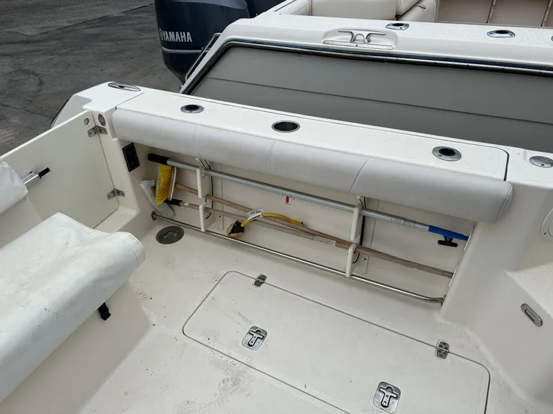 Slide: The Image of 2011 Pursuit OS 315 Offshore boat interior with storage and seating area. - 8