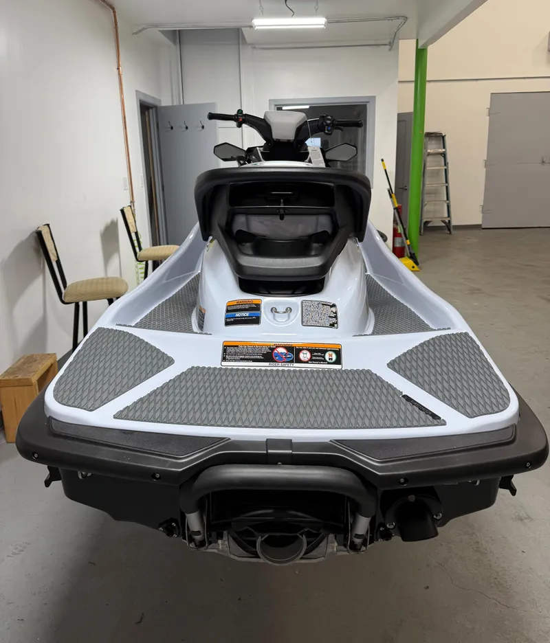 Slide: The Image of 2025 Kawasaki STX 160X jet ski in a garage, rear view showcasing sleek design. - 6