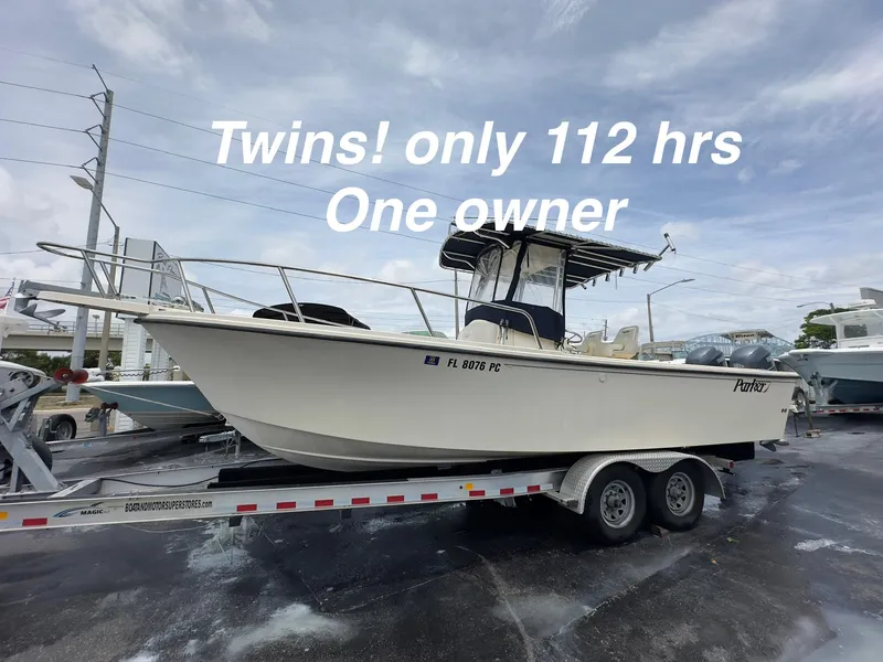 Slide: The Image of 2011 Parker 2500 Special Edition boat on trailer, "Twins! only 112 hrs, One owner" text overlay. - 0