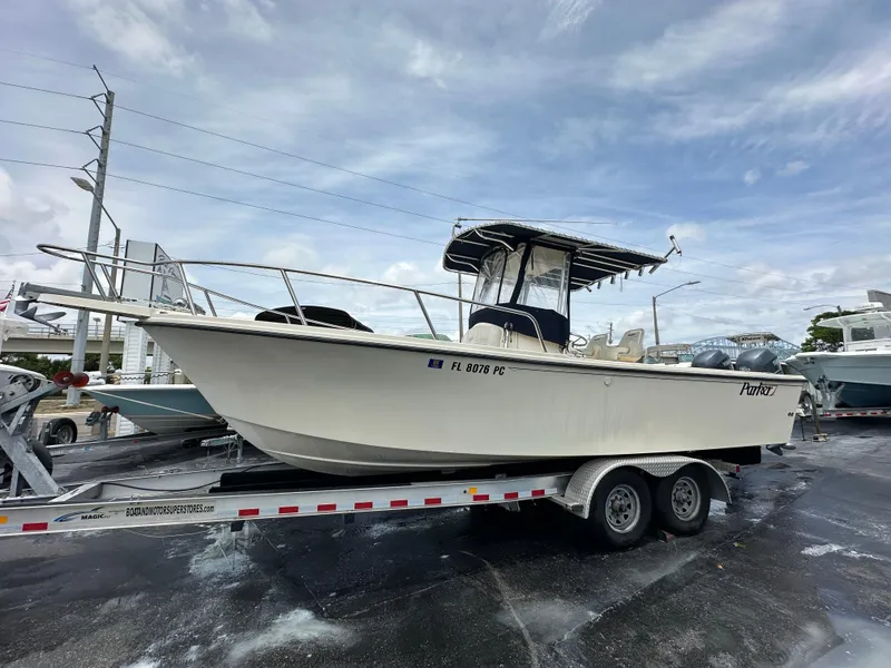 Slide: The Image of 2011 Parker 2500 Special Edition boat on trailer, parked outdoors under cloudy sky. - 3