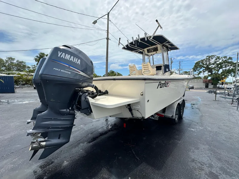 Slide: The Image of Parker 2500 Special Edition boat, 2011 model, with Yamaha outboard motor, parked outdoors. - 7