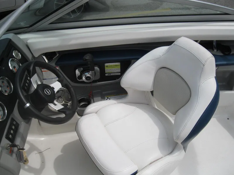 Slide: The Image of 2012 Chaparral 206 SSi boat interior with white captain's seat and steering wheel. - 11