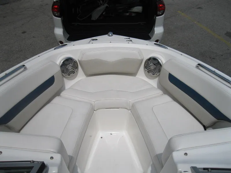Slide: The Image of 2012 Chaparral 206 SSi boat interior with white seating and speakers. - 15