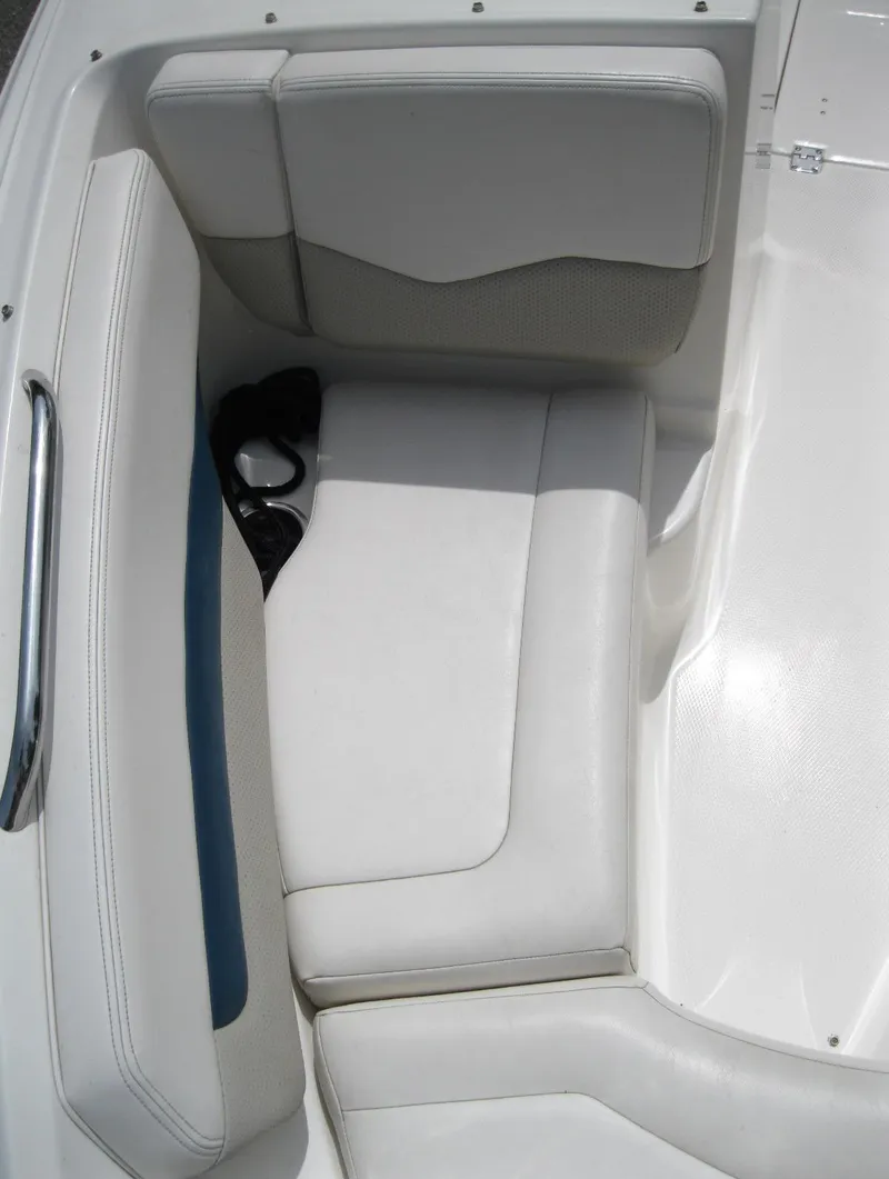 Slide: The Image of 2012 Chaparral 206 SSi boat interior seating with white upholstery and cup holders. - 17