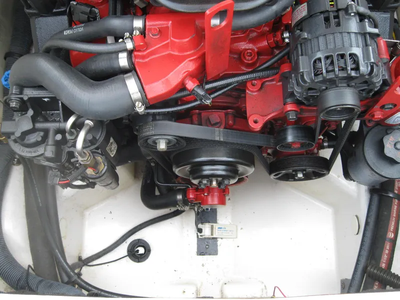 Slide: The Image of Engine compartment of a 2012 Chaparral 206 SSi boat, featuring red and black components. - 28