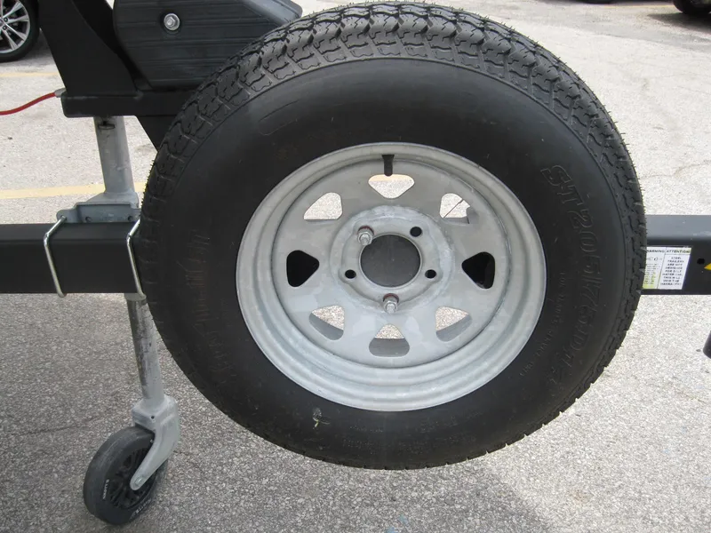 Slide: The Image of Trailer wheel for 2012 Chaparral 206 SSi boat on pavement. - 33