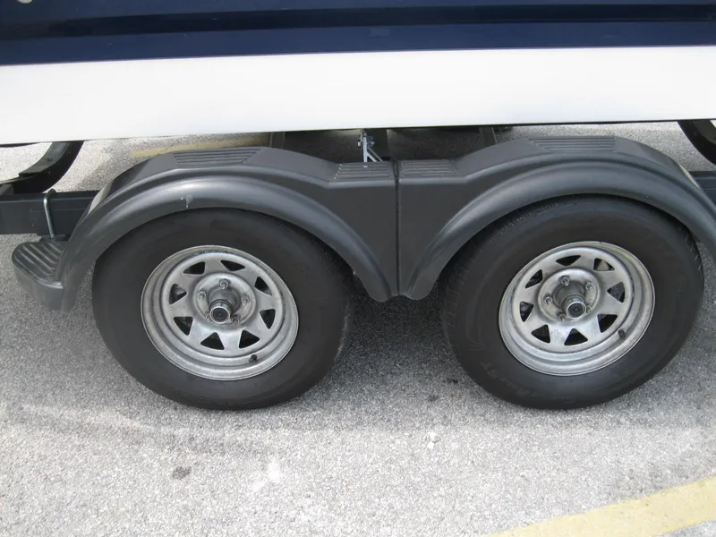 Slide: The Image of Trailer wheels of a 2012 Chaparral 206 SSi boat on pavement. - 34