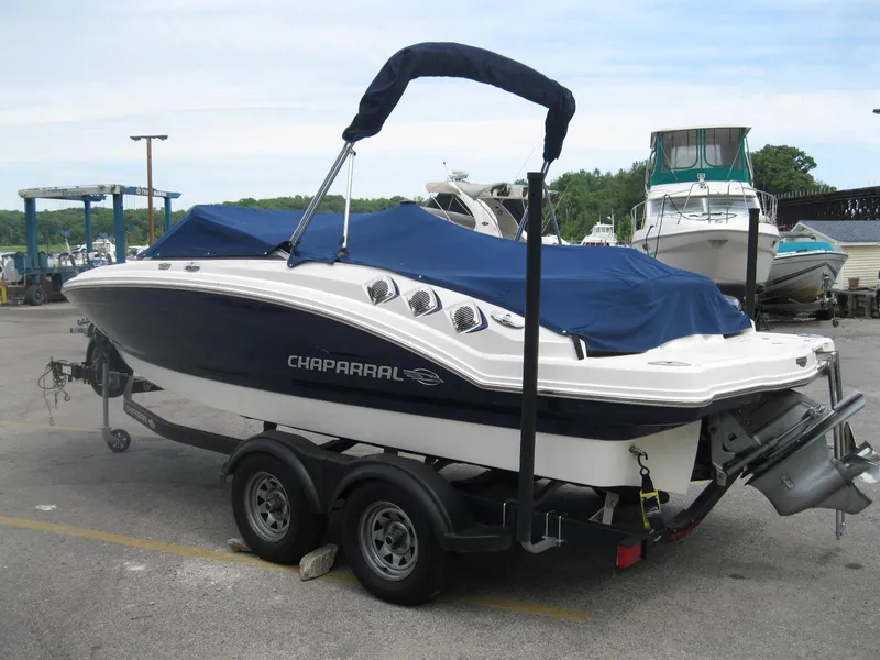 Slide: The Image of 2012 Chaparral 206 SSi boat on trailer with blue cover in marina parking lot. - 4