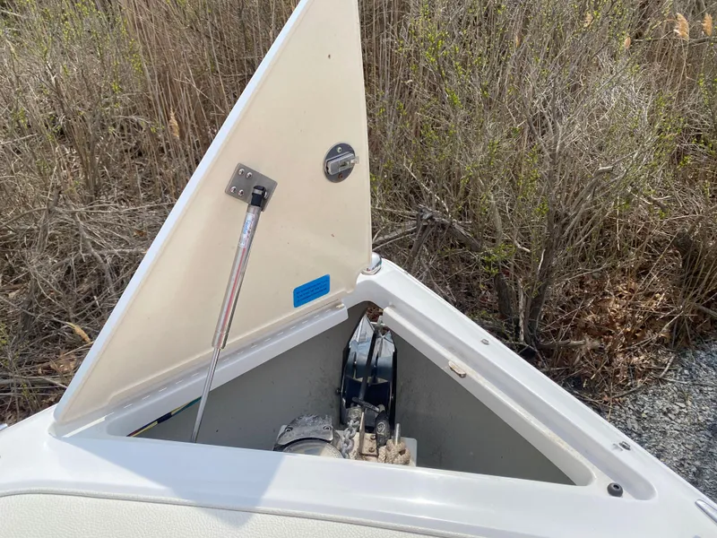Slide: The Image of Open storage compartment on 2018 Cobalt R5 boat, showing anchor and mechanism. - 12