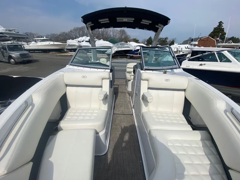 Slide: The Image of 2018 Cobalt R5 boat with white seating, docked among other boats. - 13