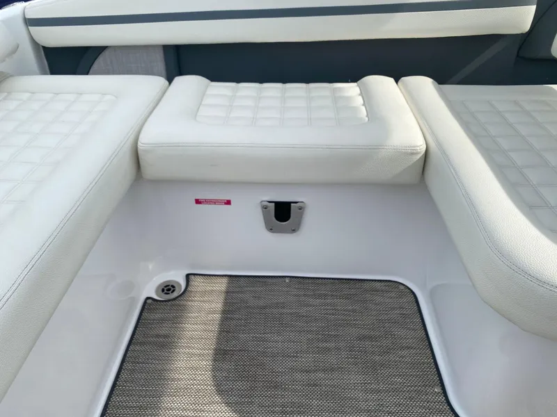 Slide: The Image of 2018 Cobalt R5 boat interior with white cushioned seating and carpeted flooring. - 14