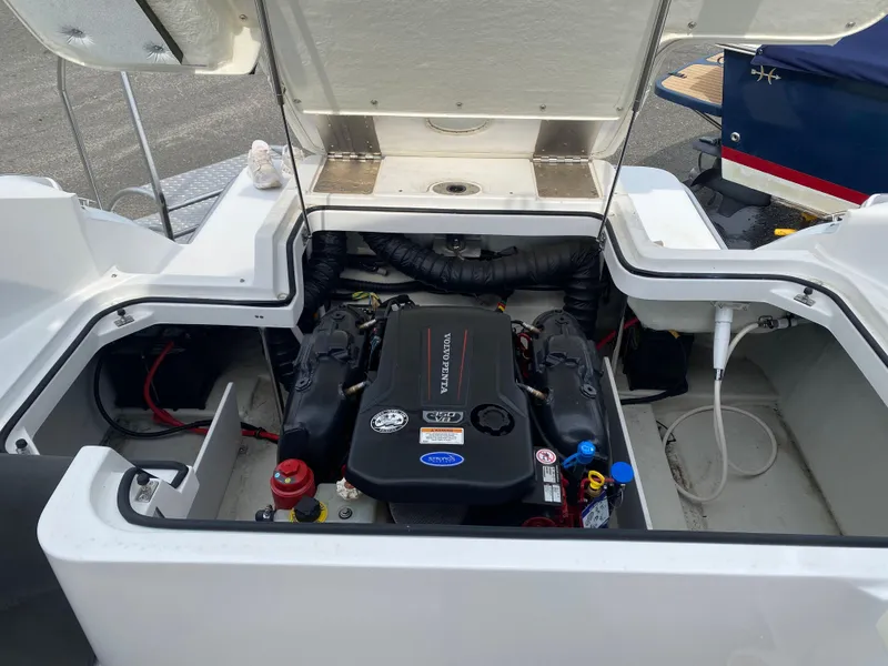 Slide: The Image of 2018 Cobalt R5 boat engine compartment with open hatch, showcasing engine components. - 21