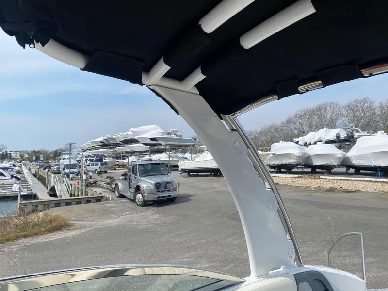 Slide: The Image of 2018 Cobalt R5 boat at marina with parked vehicles and covered boats. - 5