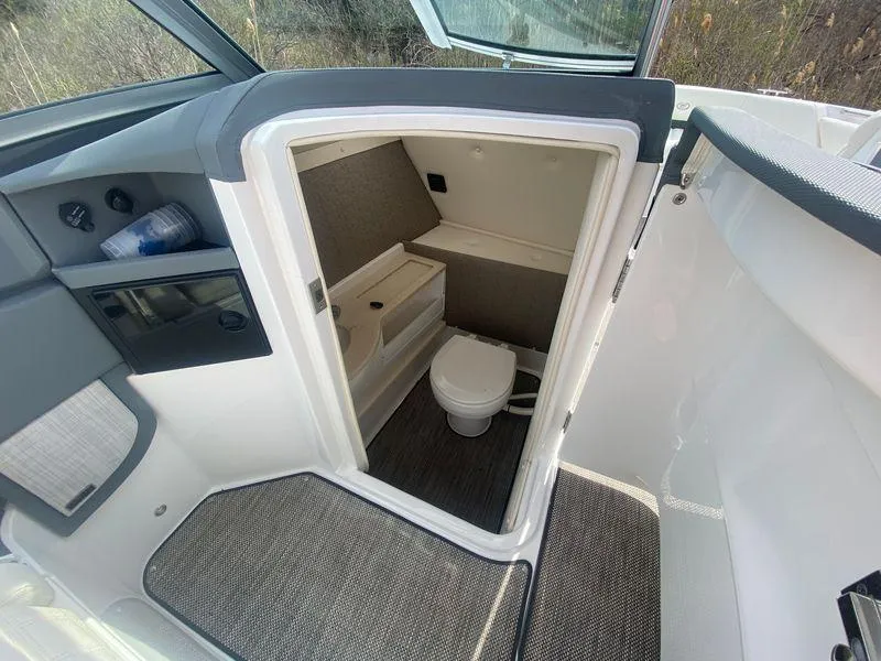 Slide: The Image of 2018 Cobalt R5 boat interior with compact bathroom and toilet. - 7
