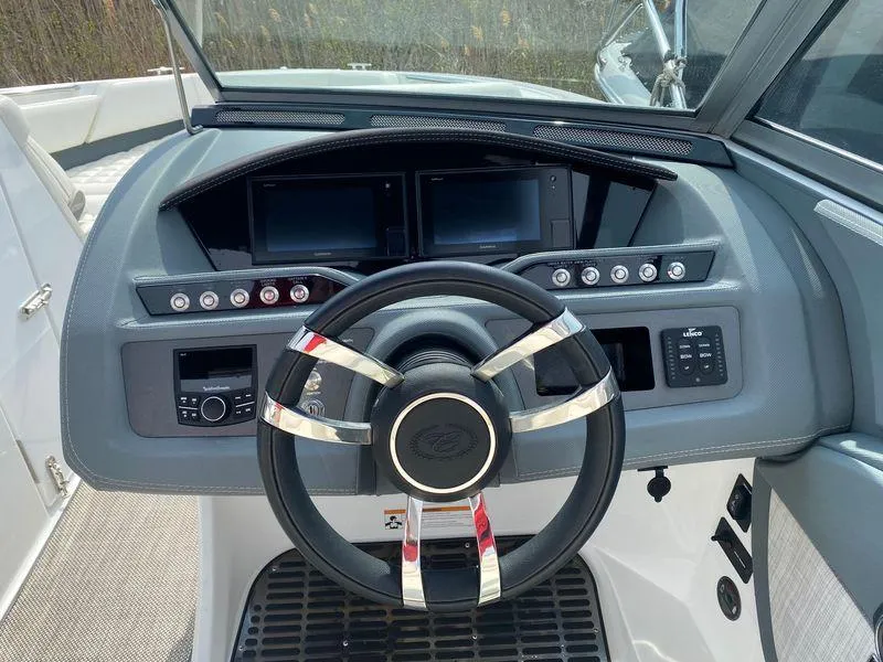 Slide: The Image of Steering wheel and dashboard of a 2018 Cobalt R5 boat, featuring modern controls and displays. - 8