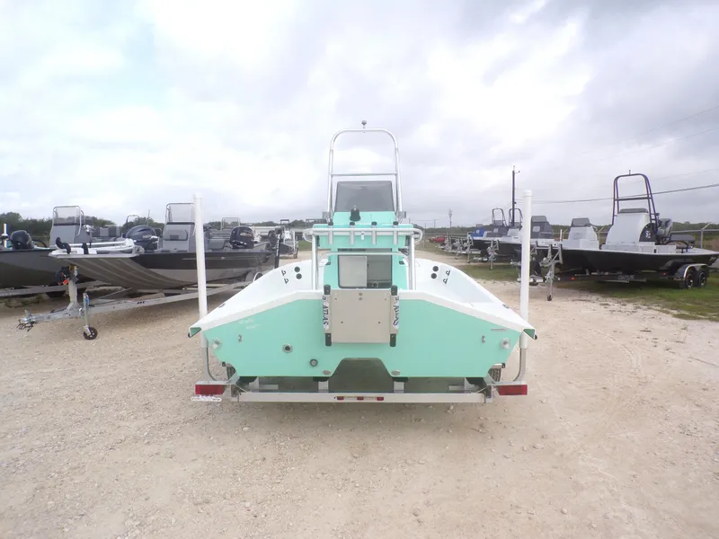 Slide: The Image of 2025 Freedom Eagle 16 boat, rear view, parked on gravel lot with other boats. - 10