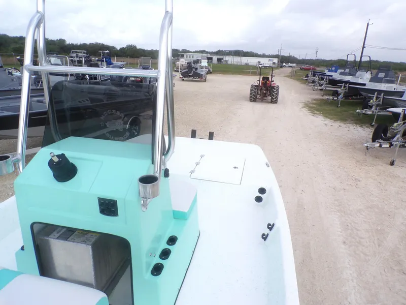 Slide: The Image of Boat interior view, Freedom Eagle 16, 2025 model, parked near trailers and a tractor. - 17