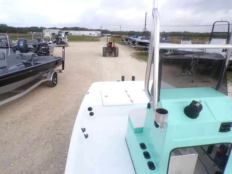 Slide: The Image of 2025 Freedom Eagle 16 boat on trailer, surrounded by other boats and a tractor in a yard. - 18