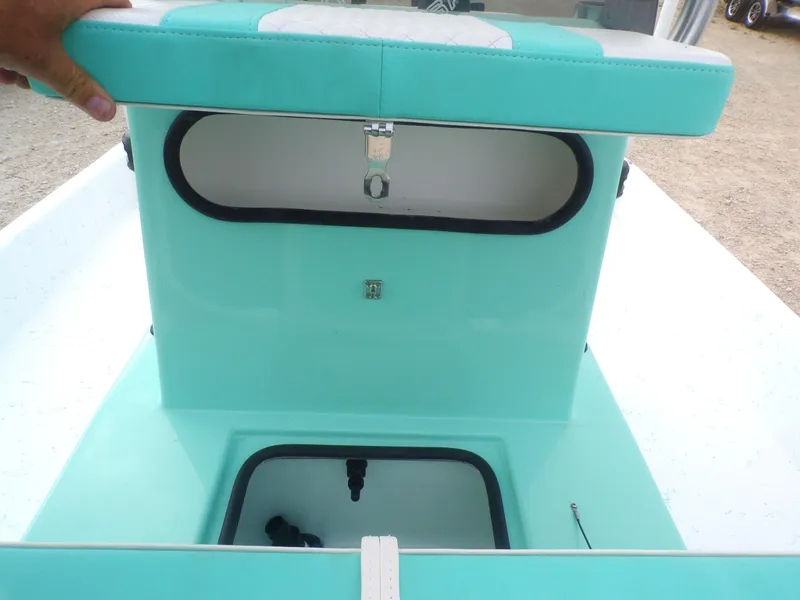 Slide: The Image of 2025 Freedom Eagle 16 boat storage compartments with teal upholstery. - 20