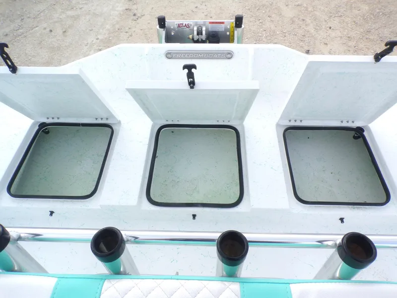 Slide: The Image of 2025 Freedom Eagle 16 boat with open storage compartments and rod holders. - 21
