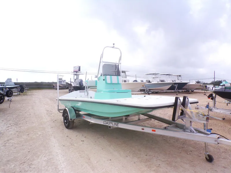 Slide: The Image of 2025 Freedom Eagle 16 boat on trailer, parked outdoors under cloudy sky. - 7