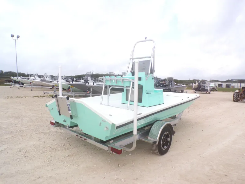 Slide: The Image of 2025 Freedom Eagle 16 boat on trailer, mint green, parked outdoors. - 9