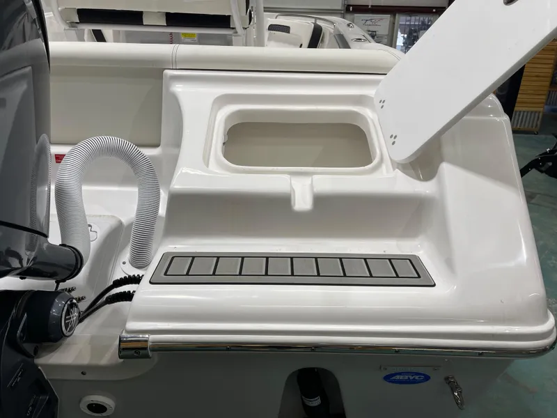 Slide: The Image of 2025 Tidewater 220LXF boat detail showing deck features and storage compartment. - 11