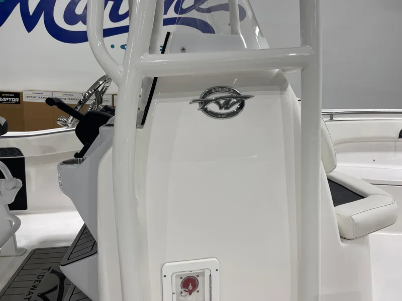 Slide: The Image of 2025 Tidewater 220LXF boat interior with steering console and seating. - 13