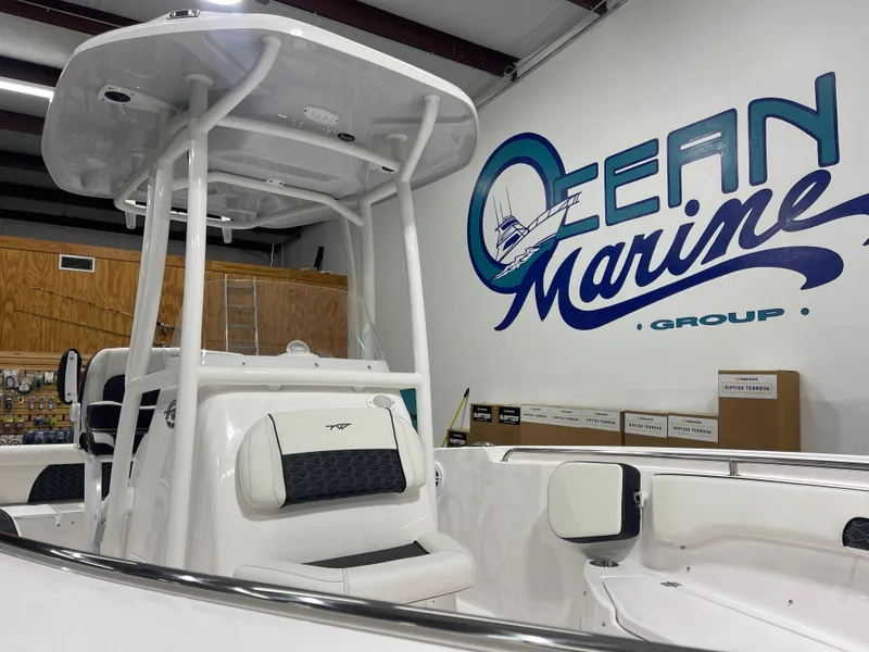 Slide: The Image of 2025 Tidewater 220LXF boat displayed at Ocean Marine Group showroom. - 14