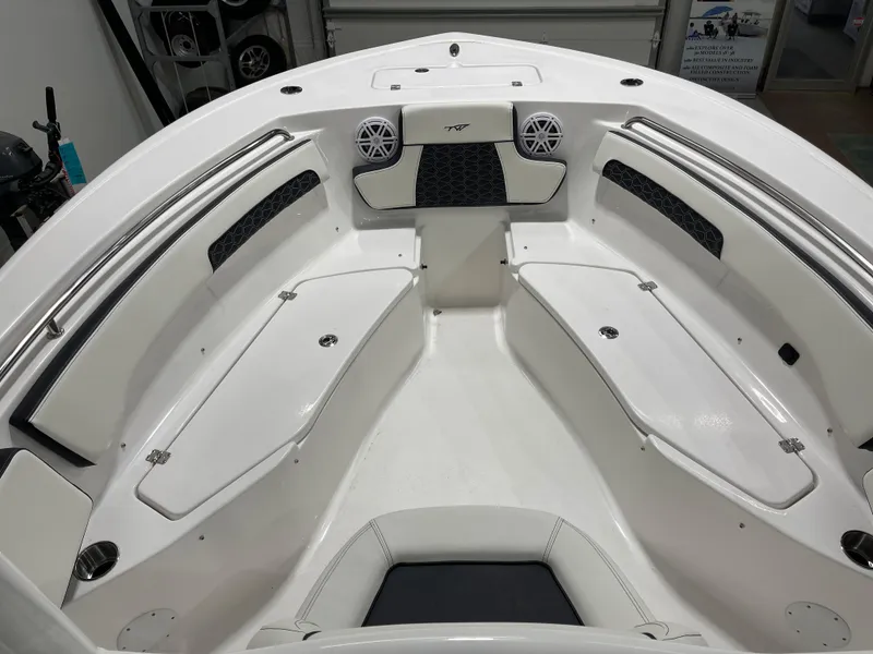 Slide: The Image of 2025 Tidewater 220LXF boat interior with white seating and storage compartments. - 15