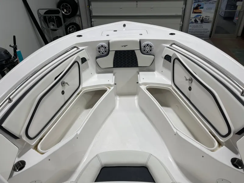 Slide: The Image of 2025 Tidewater 220LXF boat interior with storage compartments and speakers. - 16