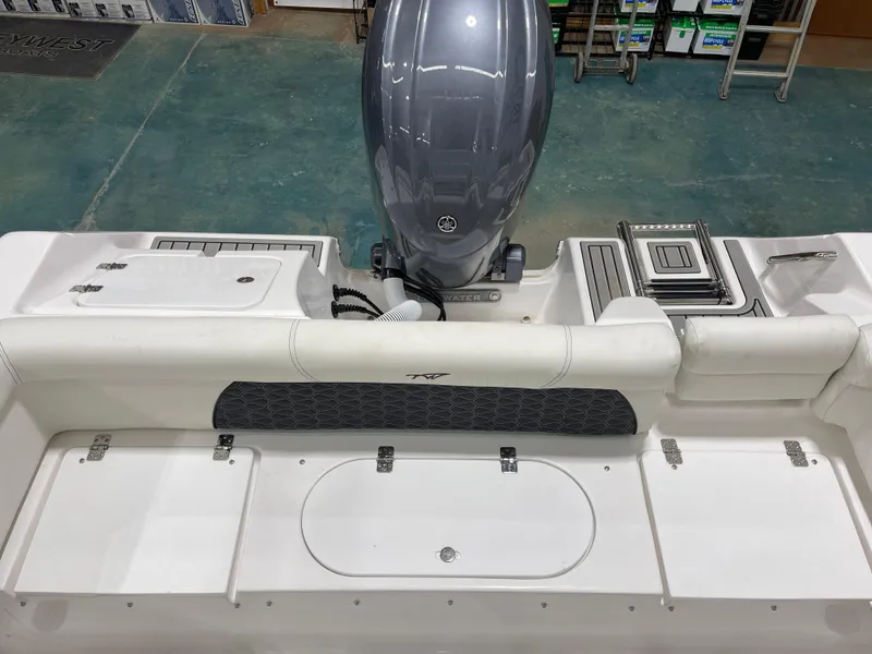 Slide: The Image of 2025 Tidewater 220LXF boat interior with Yamaha engine, featuring seating and storage compartments. - 18