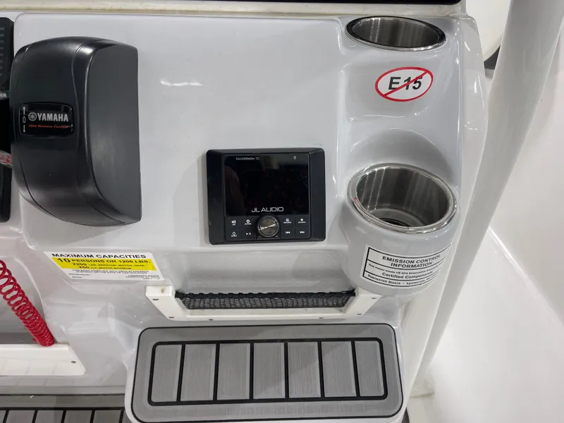 Slide: The Image of 2025 Tidewater 220LXF boat console with Yamaha controls, JL Audio system, and cup holders. - 24