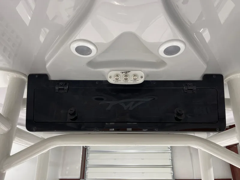 Slide: The Image of 2025 Tidewater 220LXF boat console with controls and storage compartment. - 25