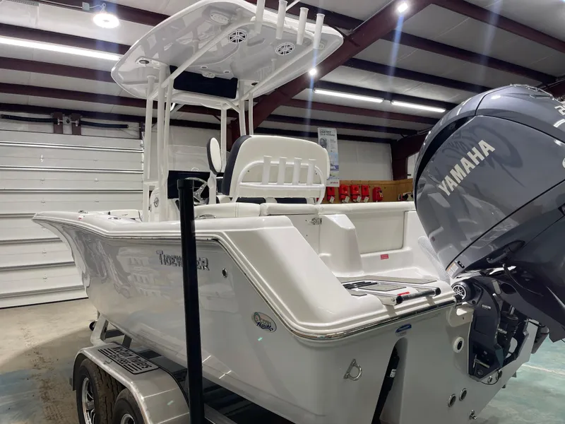 Slide: The Image of 2025 Tidewater 220LXF boat with Yamaha engine in a well-lit garage. - 7