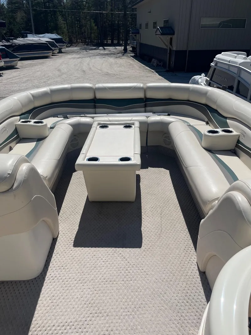 Slide: The Image of 2004 Bennington 2250 RL pontoon boat with spacious seating and central table. - 3