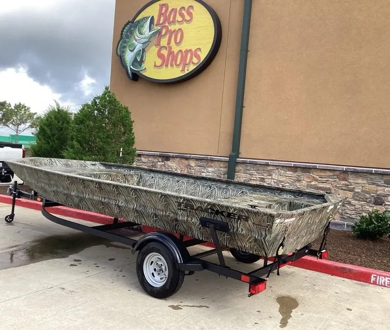 Slide: The Image of 2025 Tracker GRIZZLY 1860 Utility boat on trailer outside Bass Pro Shops. - 2