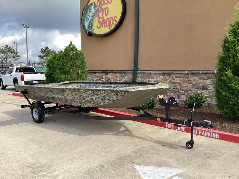 Slide: The Image of 2025 Tracker GRIZZLY 1860 Utility boat on trailer outside Bass Pro Shops. - 4