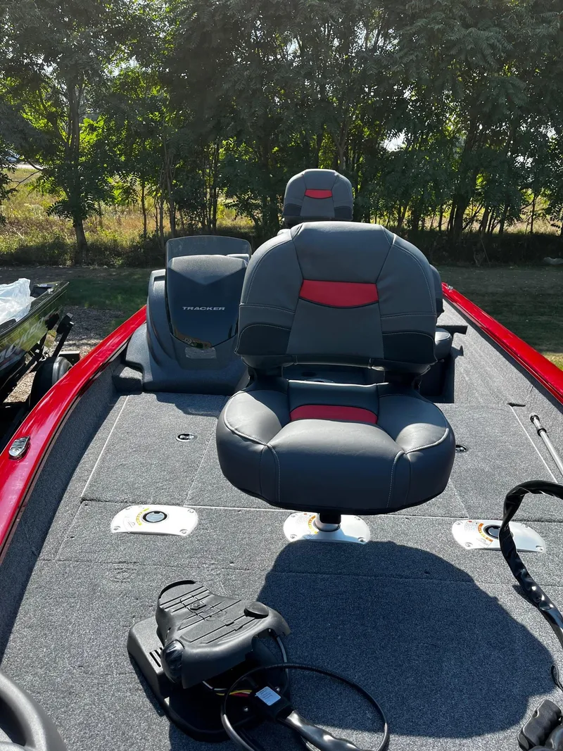 Slide: The Image of 2025 Tracker Pro Team 175 Crappie Edition boat with seating and motor, outdoors. - 4