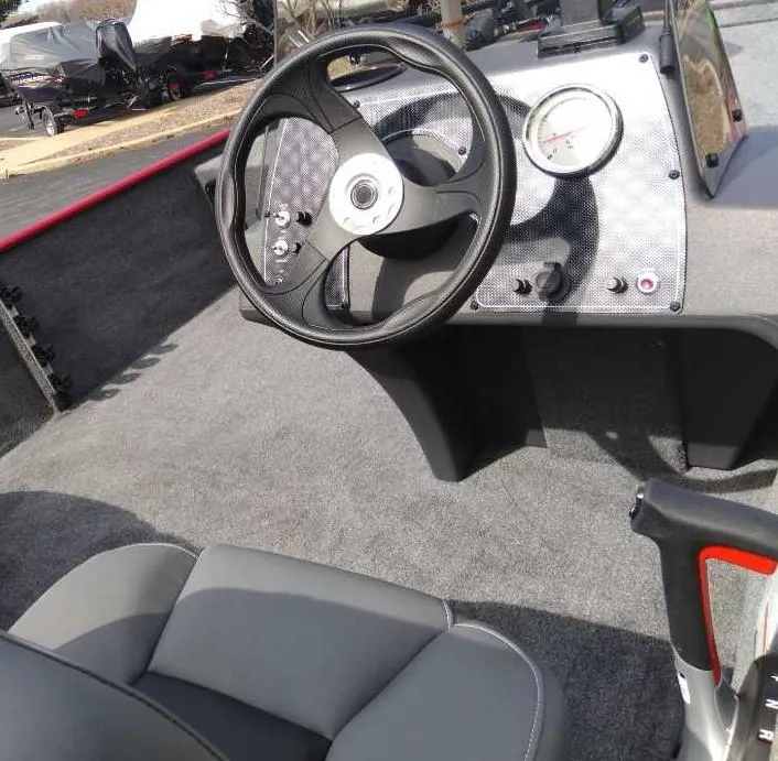 Slide: The Image of 2025 Tracker Bass Tracker Classic XL boat interior with steering wheel and dashboard. - 2