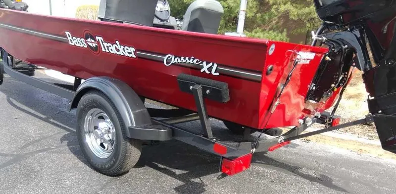 Slide: The Image of 2025 Tracker Bass Tracker Classic XL boat on trailer, red exterior, rear view. - 3