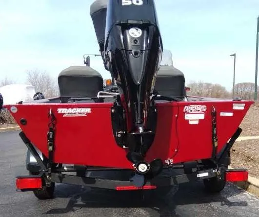 Slide: The Image of 2025 Tracker Bass Tracker Classic XL boat, rear view with motor, on a trailer. - 4