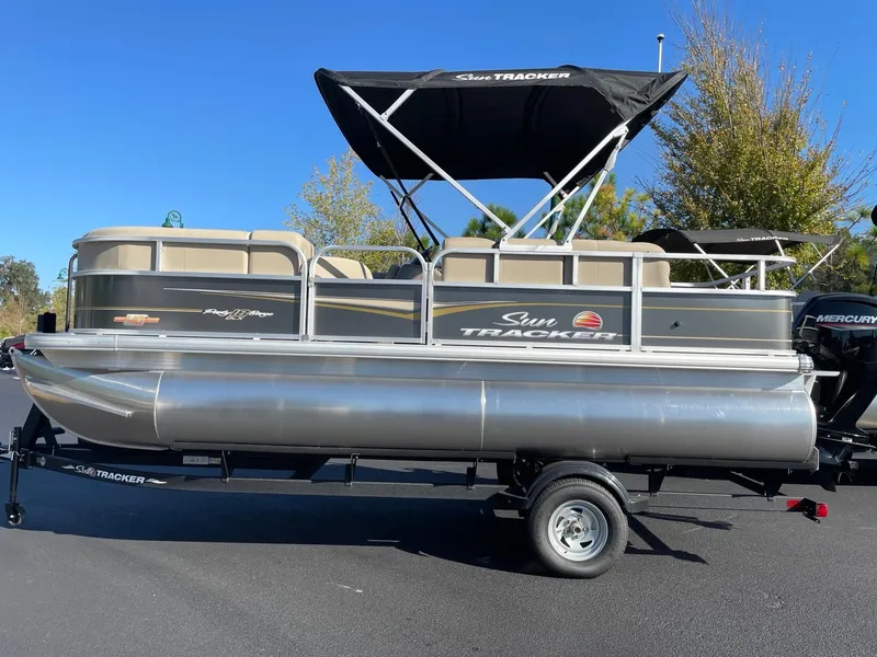 The Image of 2025 Sun Tracker Party Barge 18 DLX pontoon boat with canopy on trailer. - 0