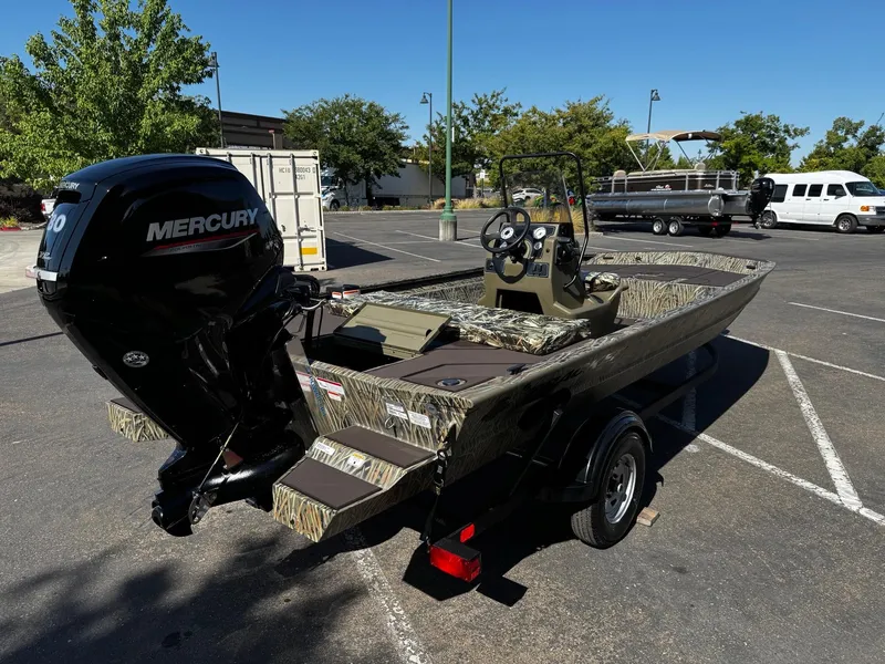 Slide: The Image of 2025 Tracker Grizzly 1860 CC boat with Mercury engine in parking lot. - 4