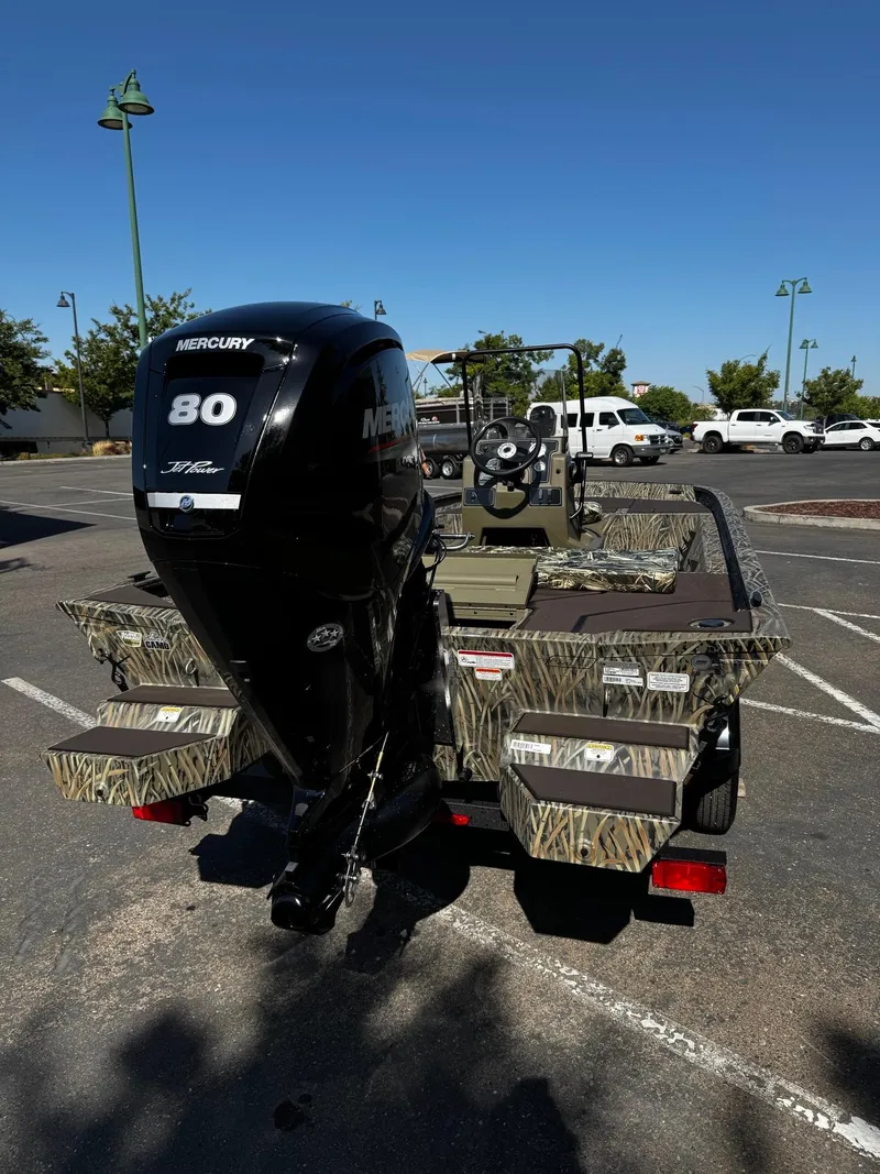 Slide: The Image of 2025 Tracker Grizzly 1860 CC boat with Mercury 80 engine in parking lot. - 6