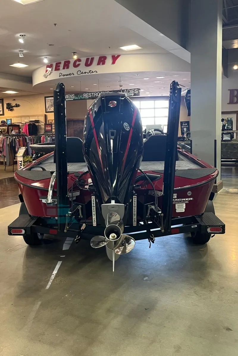 Slide: The Image of 2025 Tracker Savage 215 boat displayed indoors at a dealership. - 8