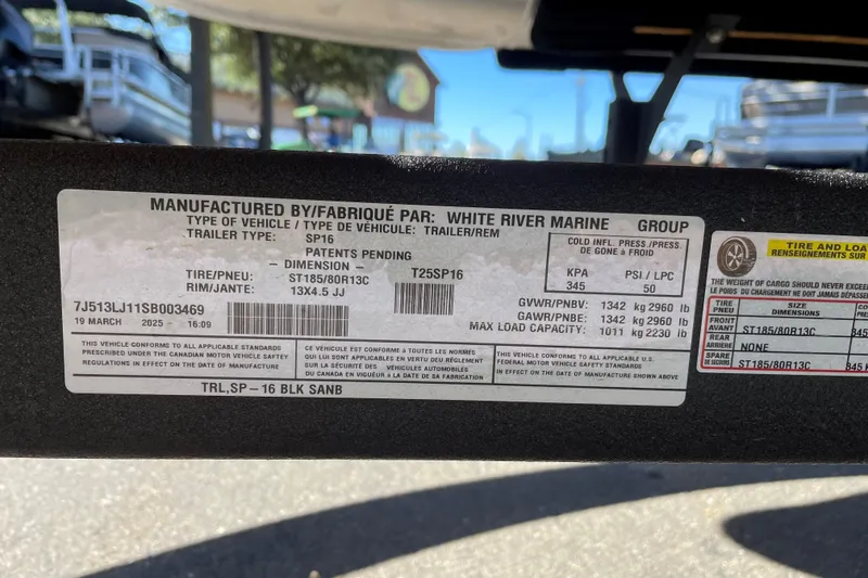 Slide: The Image of 2025 Sun Tracker Party Barge 16 DLX trailer label, specifications and compliance details. - 52